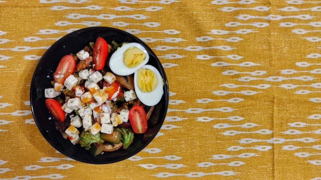 vegetable salad on black ceramic bowl